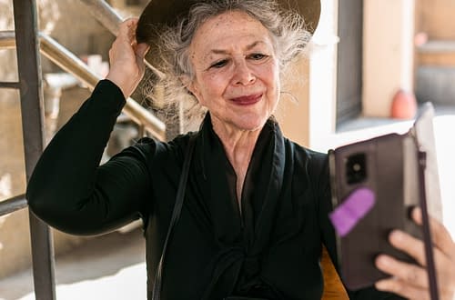 elderly woman with hat taking a selfie
