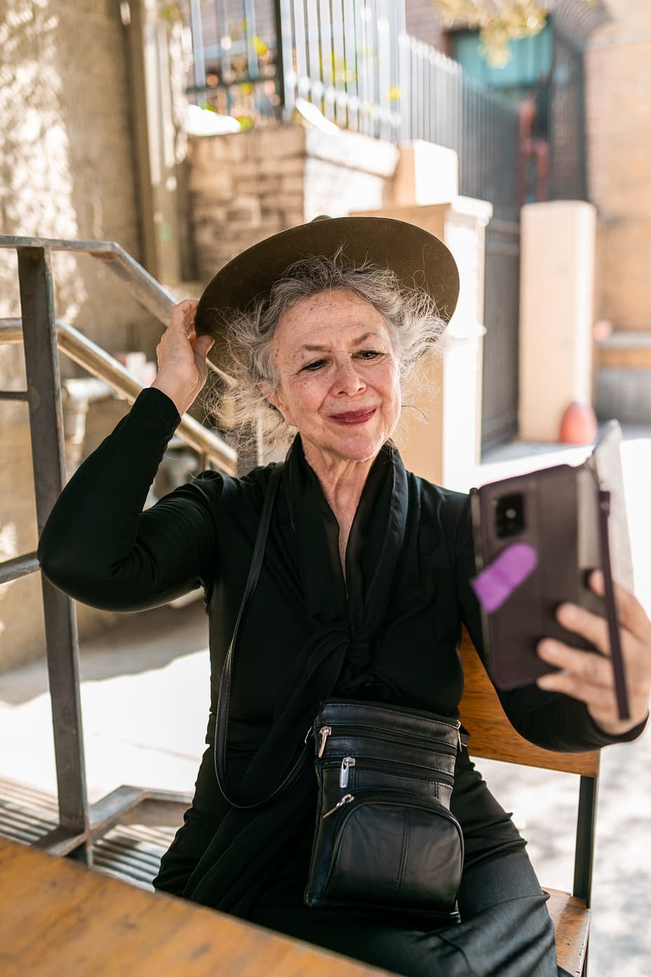 elderly woman with hat taking a selfie