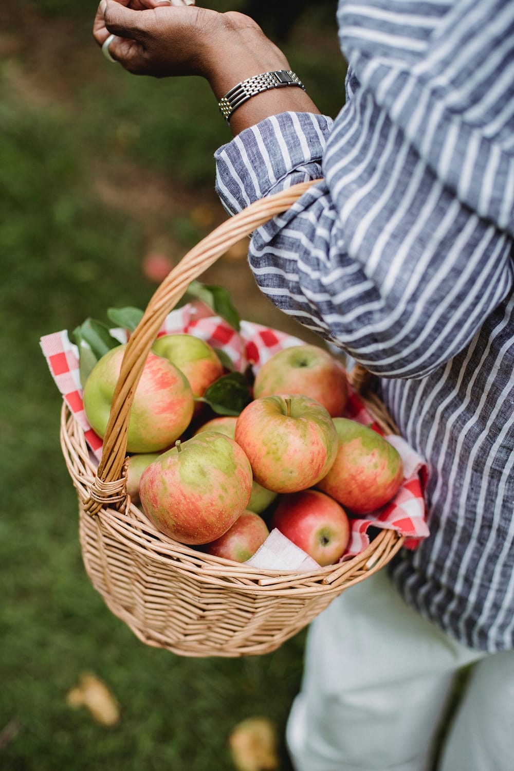a woman carrying apples
