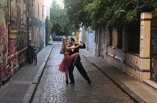 man and woman dancing tango in the street
