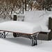 bench and table snow covered in a garden